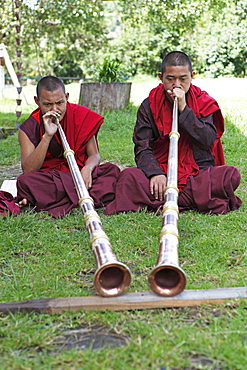 Monks playing tibetan horns, Chimi Temple, Punakha District, Bhutan, Asia