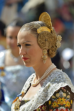 Fallas festival, woman in a traditional costume during the parade in the Plaza de la Virgen de los Desamparados, Valencia, Spain, Europe