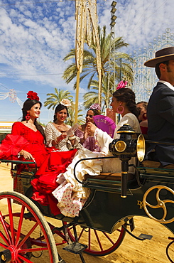 Young ladies wearing gypsy dresses at the Feria del Caballo Horse Fair, Jerez de la Frontera, Cadiz province, Andalusia, Spain, Europe