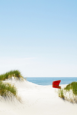 Red beach chair in the dunes by the sea, Amrum, North Frisian Islands, Schleswig-Holstein, Germany, Europe