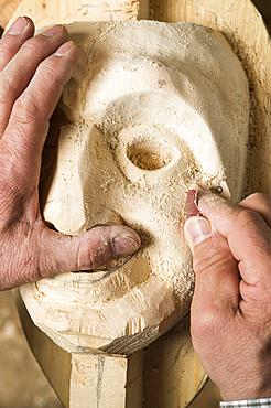 Sanding the face of a wooden mask, wooden mask carver, Bad Aussee, Styria, Austria, Europe