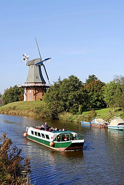 Excursion boat and a windmill, one of the twin mills of Greetsiel, East Frisia, Lower Saxony, Germany, Europe