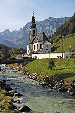 Pfarrkirche Sankt Sebastian or St. Sebastian parish church, with Ramsauer Ache river, Reiteralpe alpine pasture in the back, Ramsau, Upper Bavaria, Germany, Europe