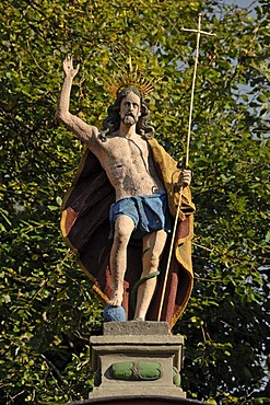 Sculpture of Christ, right hand raised in blessing, holding a crucifix in his left hand, at the entrance to Salvatorkirche Church, Obere Salvatorgasse, Coburg, Upper Franconia, Bavaria, Germany, Europe