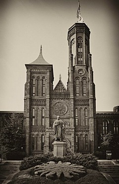 Black and white image, sepia, statue of the scientist Joseph Henry in front of the Smithsonian Institution Building, admin building and museum, commonly known as "The Castle", National Mall, Washington DC, District of Columbia, United States of America, P