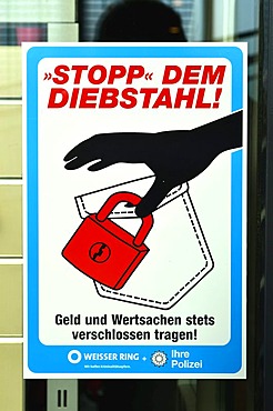 "Stopp dem Diebstahl, Geld und Wertsachen stets verschlossen tragen", German for "stop theft, always cover up your money and valuables", sign in a shop window, prevention, Weisser Ring, association to stop and prevent crime, police, Borken, Muensterland, 