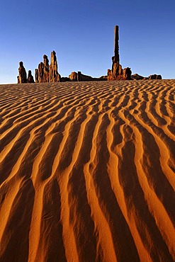 Sand dunes in front of the Totem Pole and Yei Bi Chei rock formations after sunrise, Monument Valley, Navajo Tribal Park, Navajo Nation Reservation, Arizona, Utah, United States of America, USA