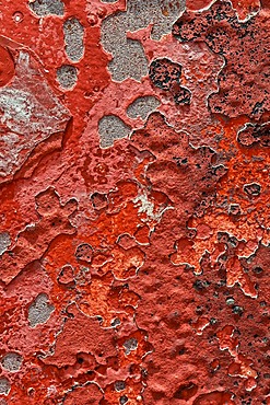 Metal surface with remnants of red paint, texture, background