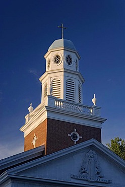 The white-steepled Saint Brigid Parish Church illuminated by soft evening light, Lexington, Massachusetts, USA