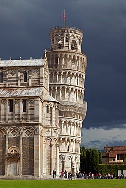 The Leaning Tower of Pisa against dark clouds, Tuscany, Italy, Europe