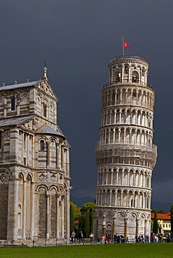 The Leaning Tower of Pisa against dark clouds, Tuscany, Italy, Europe