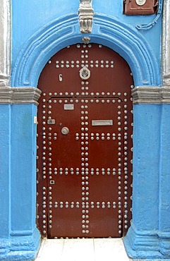 A wooden door and a blue wall in the medina of Rabat, Morocco, Africa