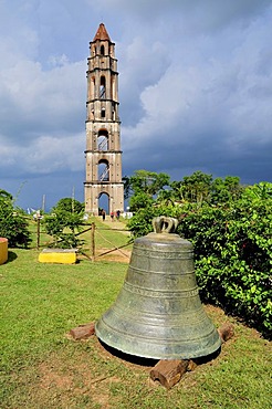 Bell in front of the seven-storeyed Iznaga Tower, a 50 meters high slave tower, Valle de los Ingenios Valley, Valley of the Sugar Mills, near Trinidad, Cuba, Caribbean