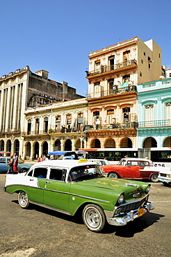 Vintage car in front of buildings with colourful facades, Habana Vieja, Old Havana, Havana, Cuba, Caribbean