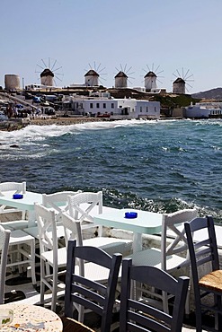 Chairs and tables of a pub, old houses by the sea, "Little Venice" district, old town of Mykonos Town, Mykonos, Greece, Europe