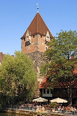 Schuldturm, medieval tower, 1323, with Celona Finca bar and cafe at front on the banks of the Pregnitz river, Vordere Insel Schuett, Nuremberg, Middle Franconia, Bavaria, Germany, Europe