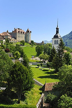 Old city walls around the medieval town, in the back Chateau de Gruyeres castle, Gruyeres, Fribourg, Switzerland, Europe