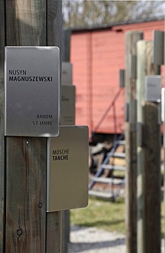 Posts with name tags of Jewish prisoners in front of a carriage used to transport the prisoners, memorial at Hessental Concentration Camp, Schwaebisch Hall, Baden-Wuerttemberg, Germany, Europe