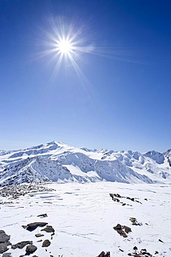 On the Hintere Schoentaufspitze peak, Solda in winter, behind Mt. Zufallspitze and Mt. Cevedale, South Tyrol, Italy, Europe