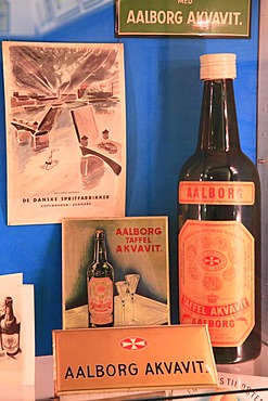 Advertising signs and old Akvavit bottle, Aalborg Akvavit spirits factory, Aalborg, North Jutland, Denmark, Europe