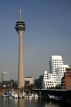 Rheinturm radio and tv tower and Gehry-Haus building, Medienhafen media harbour, Duesseldorf, North Rhine-Westphalia, Germany, Europe