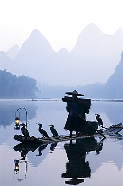 Cormorant fisherman at dawn on the Li River, Guilin, Yangshou, Guangxi Province, China, Asia