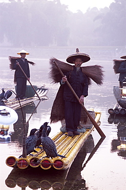 Cormorant fishermen on bamboo rafts on the Li River, Guilin, Yangshou, Guangxi Province, China, Asia