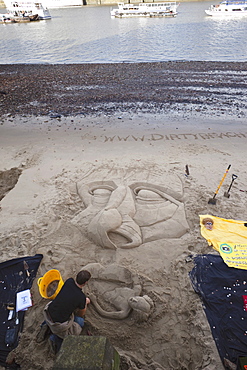 Sand sculpture on the banks of the River Thames at low tide, South Bank, London, England, United Kingdom, Europe