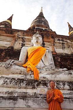 Monk in front of Buddha statue at Wat Yai Chai Mongkhon, Ayutthaya Historical Park, UNESCO World Heritage Site, Ayutthaya, Thailand, Southeast Asia, Asia