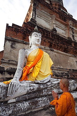 Monk in front of Buddha statue at Wat Yai Chai Mongkhon, Ayutthaya Historical Park, UNESCO World Heritage Site, Ayutthaya, Thailand, Southeast Asia, Asia