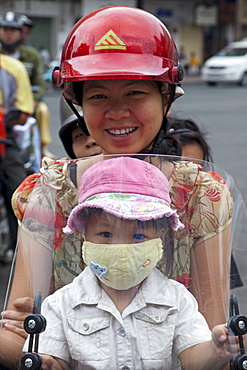 Motorbike passengers wearing pollution mask, Ho Chi Minh City, Vietnam, Indochina, Southeast Asia, Asia 