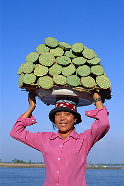 Woman carrying local produce on her head, Phnom Penh, Cambodia