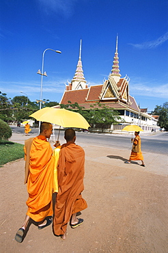 Monks walking with umbrellas, Phnom Penh, Cambodia, Indochina, Southeast Asia, Asia