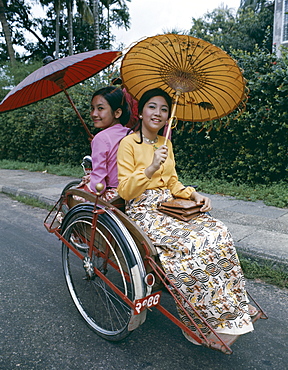 Women dressed in traditional clothes in rickshaw, Yangon, Myanmar (Burma), Asia