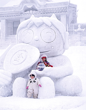 Children on snow carving, Sapporo Snow Festival (Yuki Matsuri), Sapporo, Hokkaido, Japan, Asia