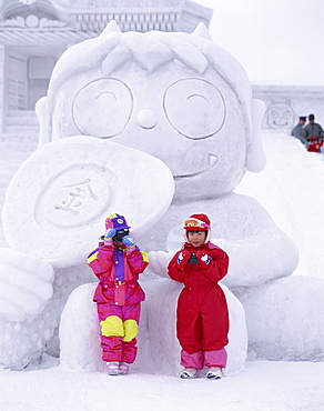 Children in front of snow carving, Sapporo Snow Festival (Yuki Matsuri), Sapporo, Hokkaido, Japan, Asia