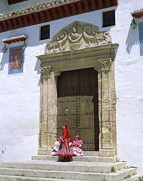 Children dressed in Andalucian costume in doorway, Granada, Andalusia, Spain, Europe