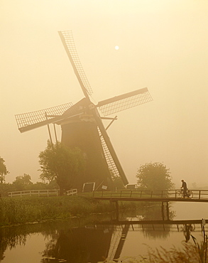 Windmill and cylist on bridge, Zaanse Schans, Holland (Netherlands), Europe