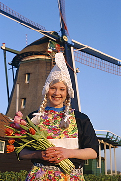 Girl dressed in Dutch costume in front of windmill, Zaanse Schans, Holland (Netherlands), Europe