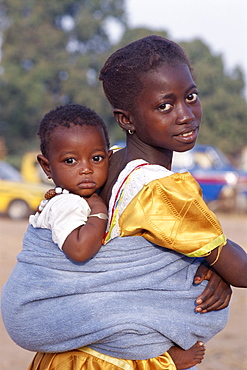 African girl carrying baby on back, Banjul, Gambia, West Africa, Africa