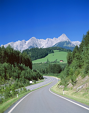 Empty road and Alps mountains, Austria, Europe