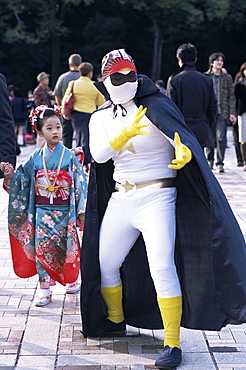 Eccentric street performer and girl in kimono at Harajuku, Tokyo, Honshu, Japan, Asia