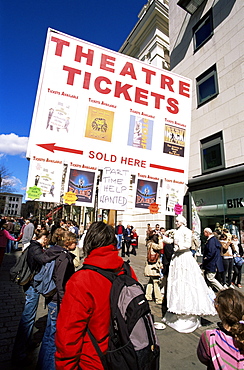 Sandwich board man advertising theatre tickets and street performer, Covent Garden, London, England, United Kingdom, Europe