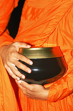 Detail of monk holding alms bowl, Bangkok, Thailand, Southeast Asia, Asia