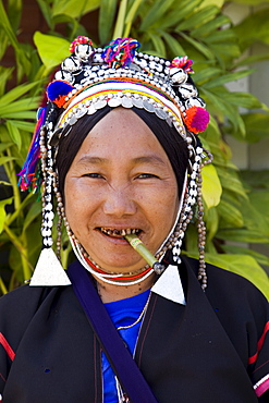 Akha hilltribe woman smoking and wearing traditional costume, Golden Triangle, Thailand, Southeast Asia, Asia