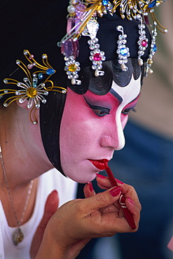 Portrait of Chinese Opera actress applying make-up, Hong Kong, China, Asia