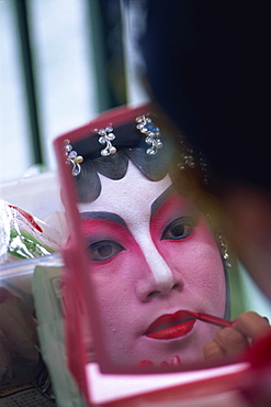 Portrait of Chinese Opera actress applying make-up, Hong Kong, China, Asia