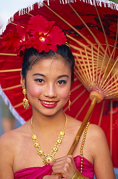 Portrait of a girl in traditional Thai costume with flowers in her hair, Chiang Mai Flower Festival Parade, Chiang Mai, Thailand, Southeast Asia, Asia