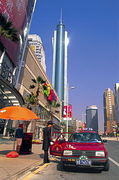 Doorman in suit and top hat opening taxi door for customers of department store, Shenzhen, Guangdong Province, China, Asia