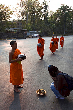 Monks receiving offerings of food, Chiang Mai, Thailand, Southeast Asia, Asia